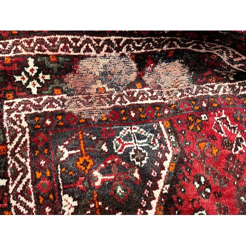 1128 - A large vintage Iranian hand knotted rug. The Persian Rug Company. 265x372cm