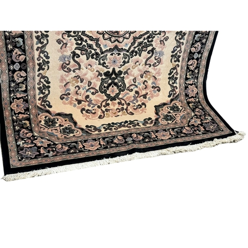 1140 - A large Middle Eastern style wool rug. 169x249xm