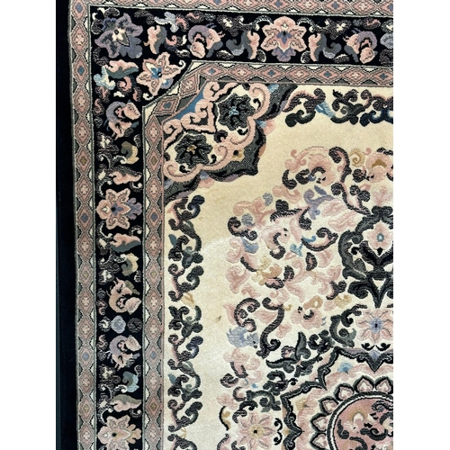 1140 - A large Middle Eastern style wool rug. 169x249xm