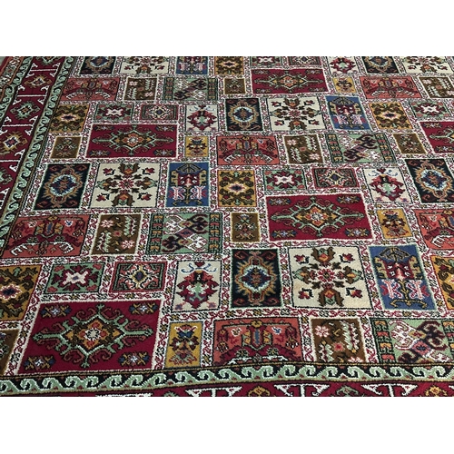 1167 - A large vintage Middle Eastern hand knotted rug. 271x364cm