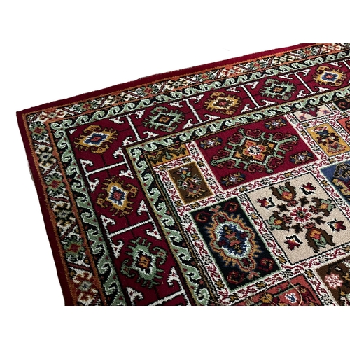 1167 - A large vintage Middle Eastern hand knotted rug. 271x364cm