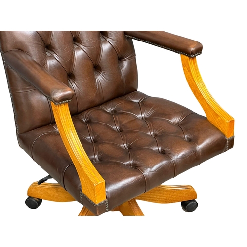 1197 - A Gainsborough style deep button leather swivel desk chair. (6)