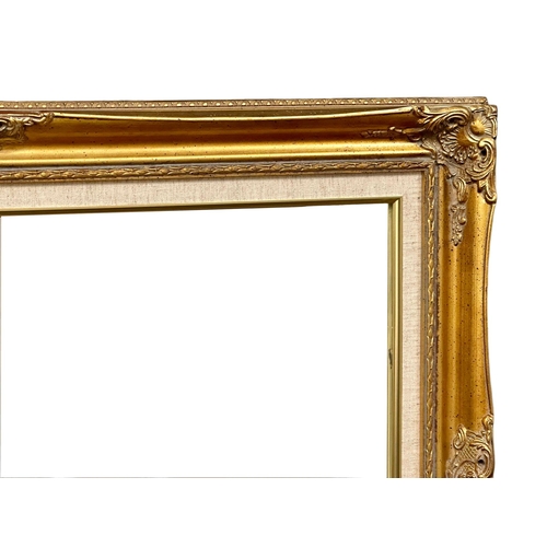 161 - An ornate gilt framed mirror. 92x67cm