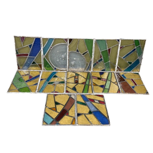 211U - A set of 12 early 20th century stained glass panels 35x49.5cm each.