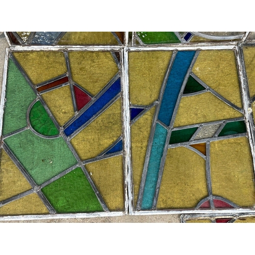 211U - A set of 12 early 20th century stained glass panels 35x49.5cm each.