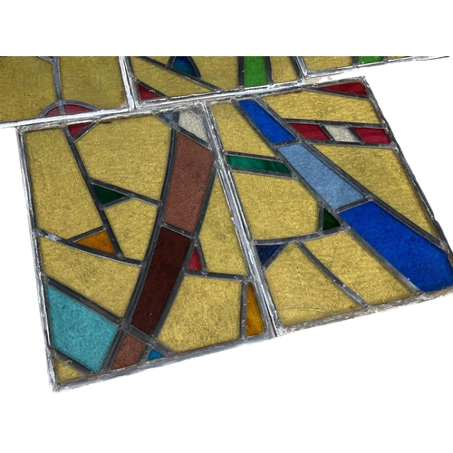 211U - A set of 12 early 20th century stained glass panels 35x49.5cm each.