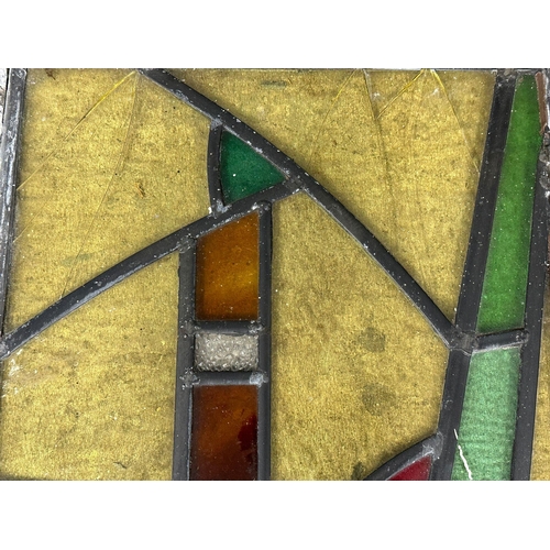 211U - A set of 12 early 20th century stained glass panels 35x49.5cm each.