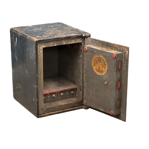 65G - An early 20th century safe. Cyrus Price & Co LTD, Wolverhampton. Little & McClean LTD, Belfast. 51x5... 