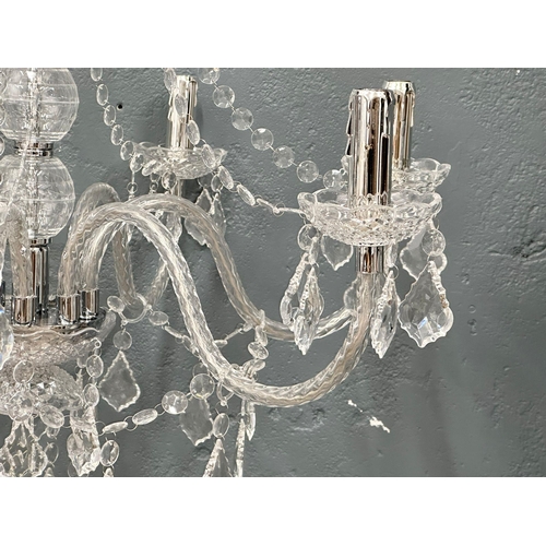 73 - A pair of large plastic chandeliers.