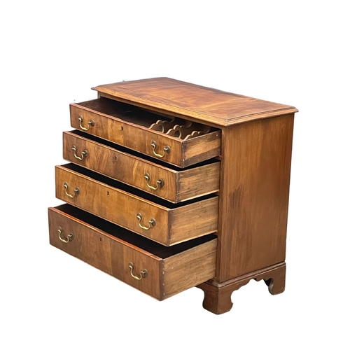 813 - A fine proportioned early George III mahogany oak lined chest of drawers with original brass drop ha... 