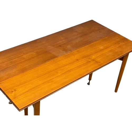 814 - An Elliots of Newbury Mid Century teak dining set. Highboard with retracting drop leaf dining table ... 