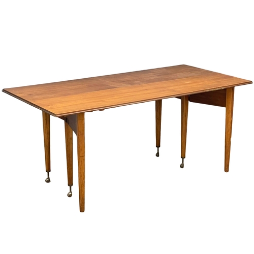 814 - An Elliots of Newbury Mid Century teak dining set. Highboard with retracting drop leaf dining table ... 