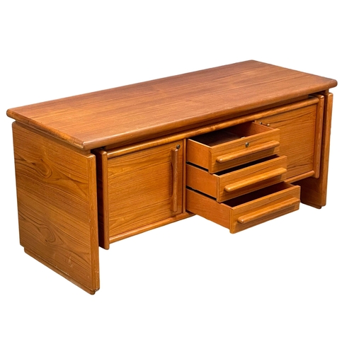 827 - A Danish Mid Century teak sideboard. 145x58x66cm (2)