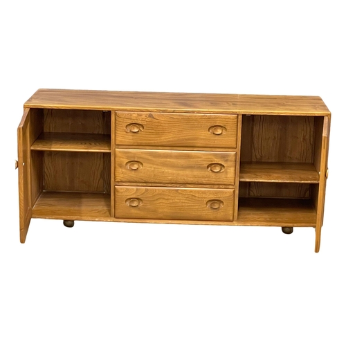 828 - An Ercol Blonde Elm model 455 Mid Century Windsor sideboard. 155x43x68cm (2)