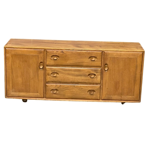 828 - An Ercol Blonde Elm model 455 Mid Century Windsor sideboard. 155x43x68cm (2)