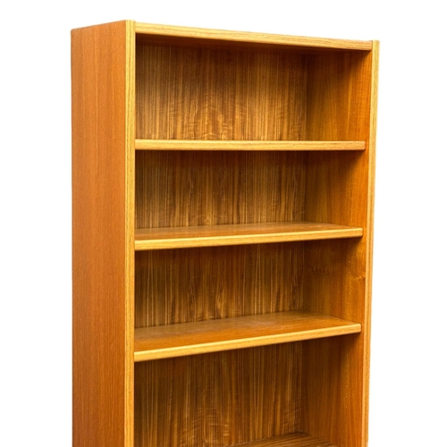 829 - A large Danish Mid Century teak open bookcase/ shelving unit. 83x32x193.5cm (8)