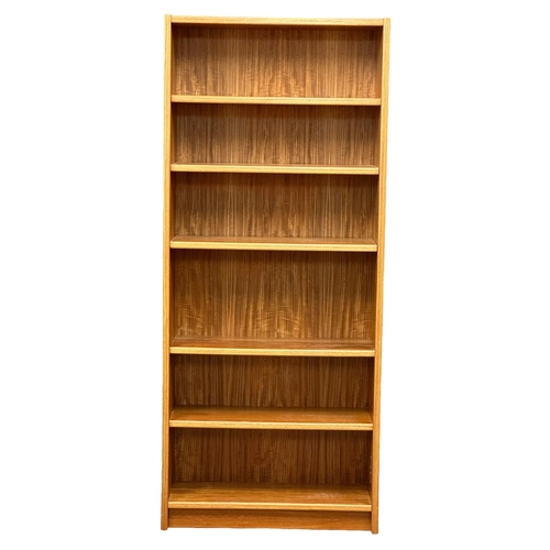 829 - A large Danish Mid Century teak open bookcase/ shelving unit. 83x32x193.5cm (8)