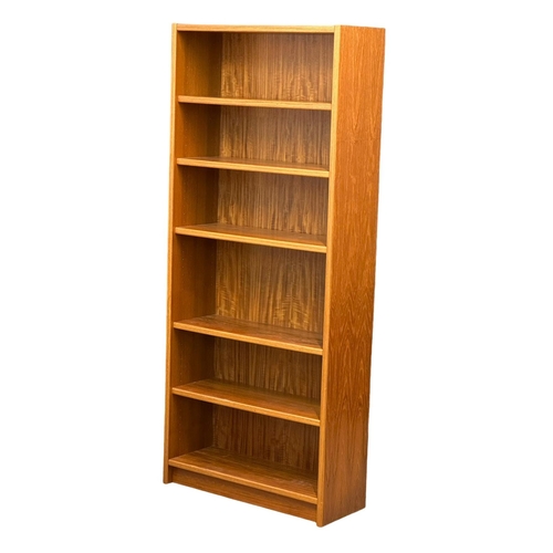 829 - A large Danish Mid Century teak open bookcase/ shelving unit. 83x32x193.5cm (8)