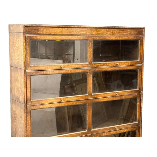 851 - A large early 20th century barristers oak stacking bookcase with 2 drawers, by Gumm. 128.5x31x162cm ... 