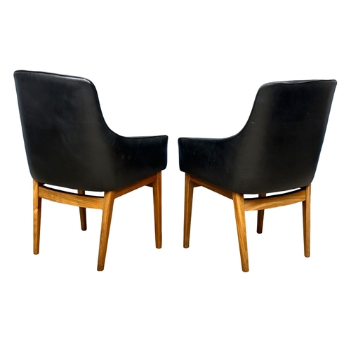 852 - A pair of good quality Mid Century teak and black vinyl armchairs. 1960’s. (8)