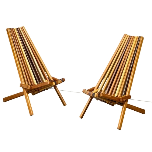 855 - A pair of Mid Century Modern teak and rosewood folding deck chairs with matching side table. (11)