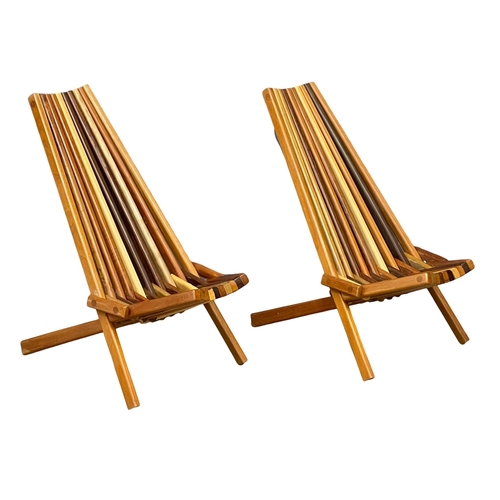 855 - A pair of Mid Century Modern teak and rosewood folding deck chairs with matching side table. (11)