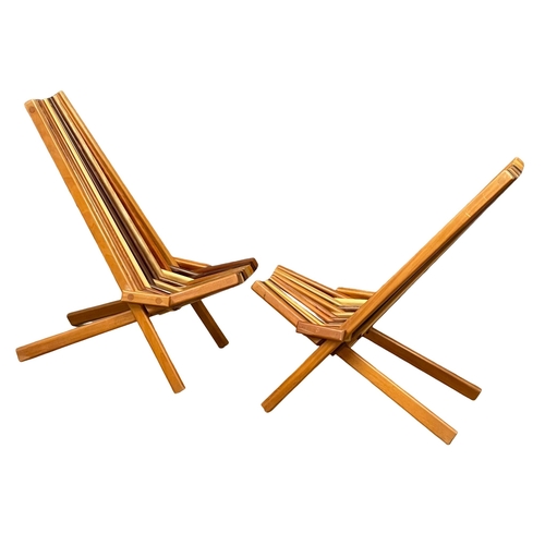 855 - A pair of Mid Century Modern teak and rosewood folding deck chairs with matching side table. (11)