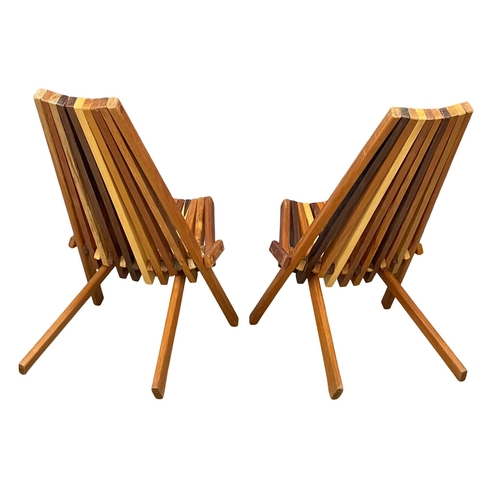 855 - A pair of Mid Century Modern teak and rosewood folding deck chairs with matching side table. (11)