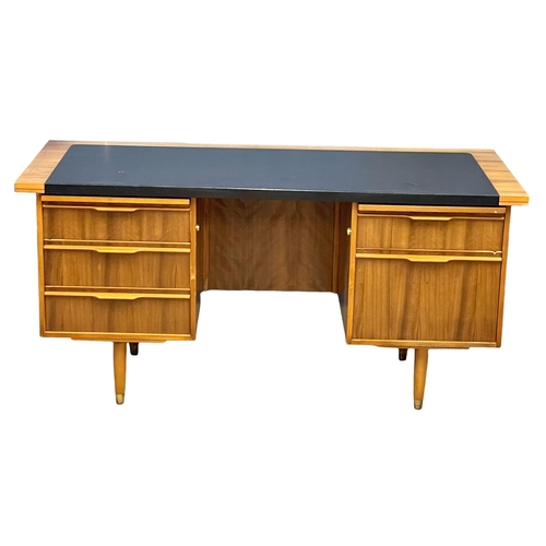 857 - A 1960’s Mid Century Tola Wood desk with black vinyl top. 160x76.5x75cm (4)