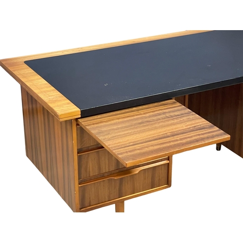 857 - A 1960’s Mid Century Tola Wood desk with black vinyl top. 160x76.5x75cm (4)