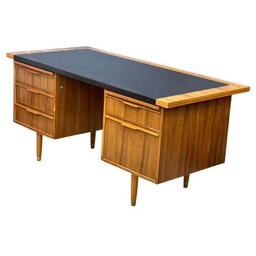 857 - A 1960’s Mid Century Tola Wood desk with black vinyl top. 160x76.5x75cm (4)