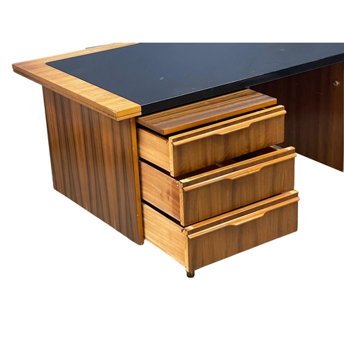 857 - A 1960’s Mid Century Tola Wood desk with black vinyl top. 160x76.5x75cm (4)