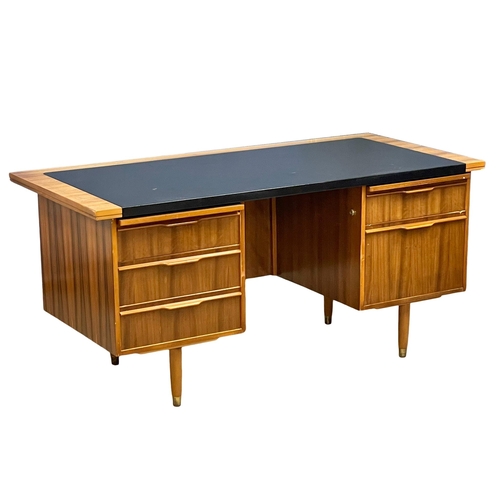 857 - A 1960’s Mid Century Tola Wood desk with black vinyl top. 160x76.5x75cm (4)