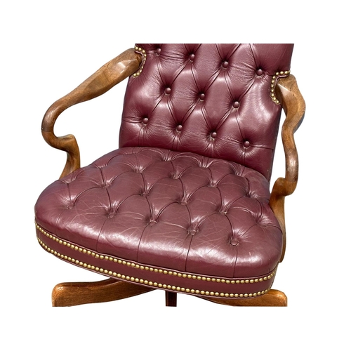 858 - A deep button leather swivel desk chair. (8)