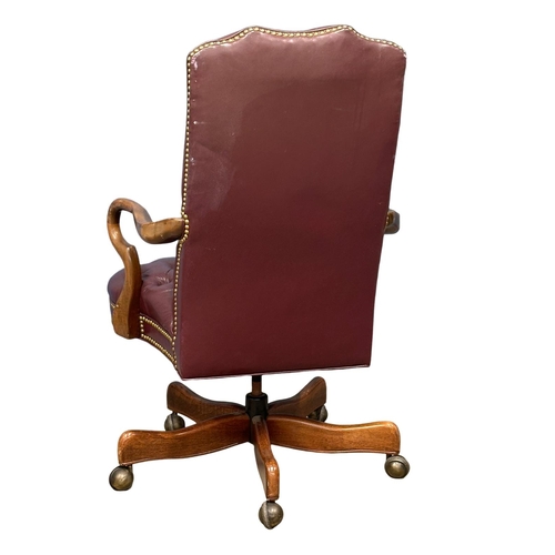 858 - A deep button leather swivel desk chair. (8)