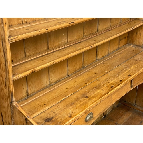 868 - A large late 19th century Irish pine kitchen dresser. 185x55x202cm (2)