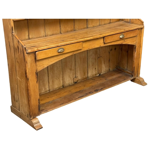 868 - A large late 19th century Irish pine kitchen dresser. 185x55x202cm (2)