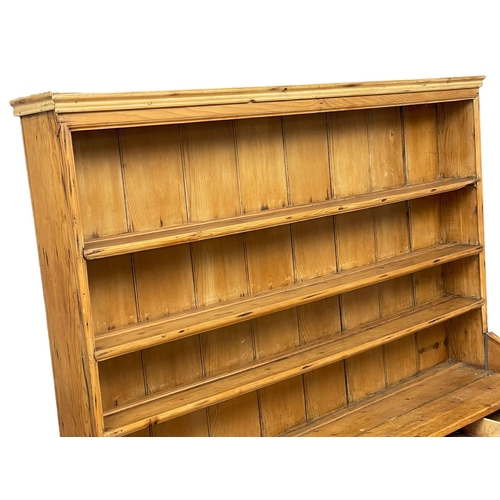 868 - A large late 19th century Irish pine kitchen dresser. 185x55x202cm (2)