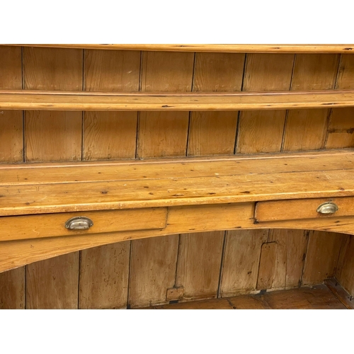 868 - A large late 19th century Irish pine kitchen dresser. 185x55x202cm (2)