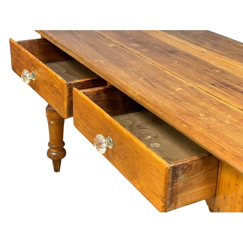 869 - A Victorian pine farmhouse kitchen table with 2 drawers and glass handles. 153x67x76cm (2)