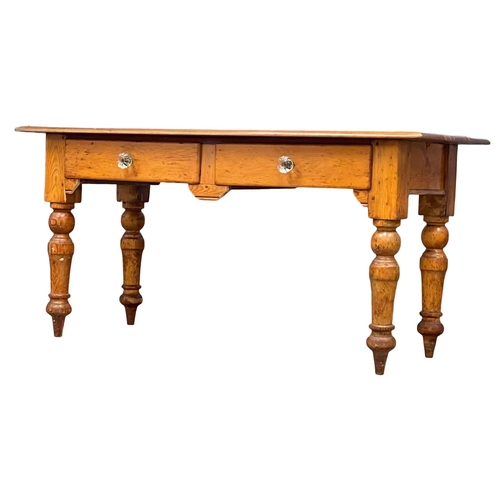 869 - A Victorian pine farmhouse kitchen table with 2 drawers and glass handles. 153x67x76cm (2)