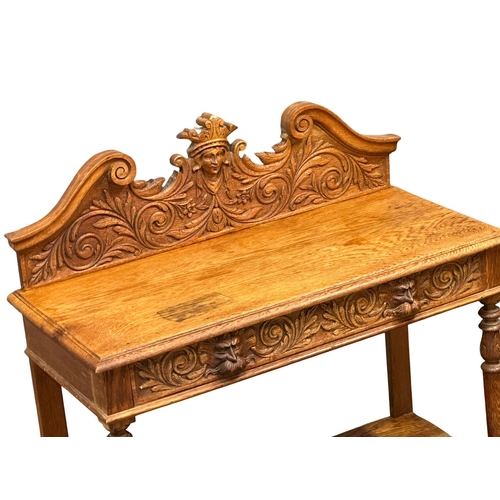 873 - A Victorian oak gallery back side table with carved Man of the Forest drawer. 105x47x105cm (5)