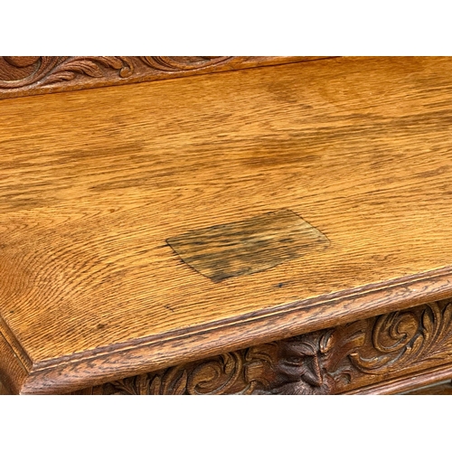 873 - A Victorian oak gallery back side table with carved Man of the Forest drawer. 105x47x105cm (5)