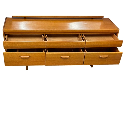 887 - A Mid Century teak dressing table by William Lawrence. 156x41x115cm (10)