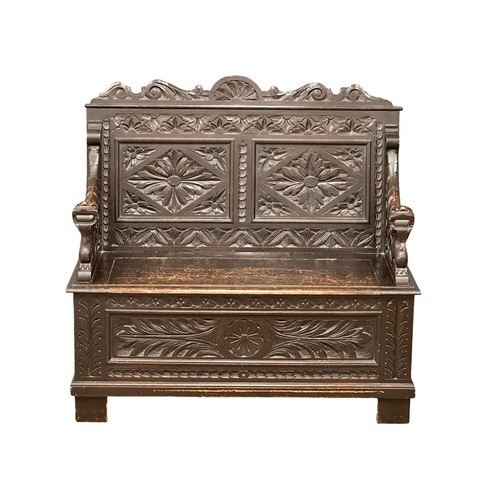 893 - A Victorian carved oak hall bench with lift up storage. Circa 1870-1880. 107x43.5x100cm (5)