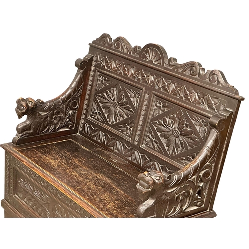 893 - A Victorian carved oak hall bench with lift up storage. Circa 1870-1880. 107x43.5x100cm (5)