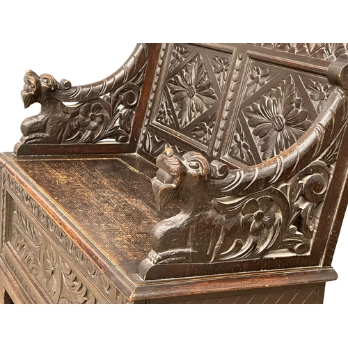 893 - A Victorian carved oak hall bench with lift up storage. Circa 1870-1880. 107x43.5x100cm (5)