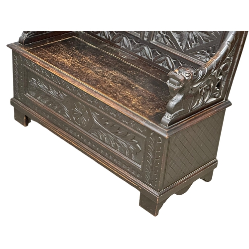 893 - A Victorian carved oak hall bench with lift up storage. Circa 1870-1880. 107x43.5x100cm (5)