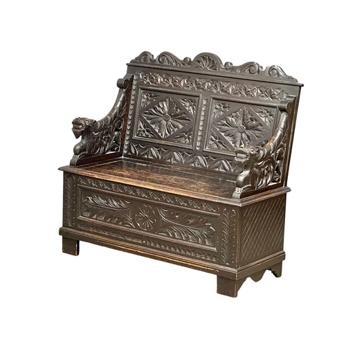 893 - A Victorian carved oak hall bench with lift up storage. Circa 1870-1880. 107x43.5x100cm (5)