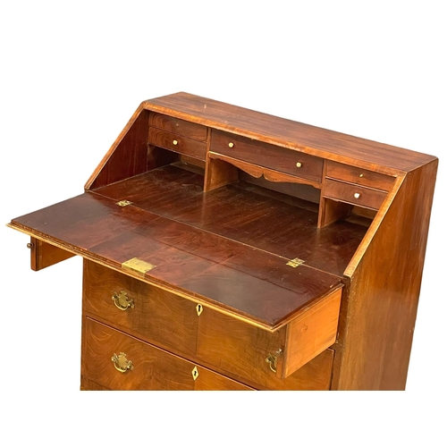 910 - A late George III mahogany writing bureau with 3 drawers and brass drop handles on bracket feet. Cir... 